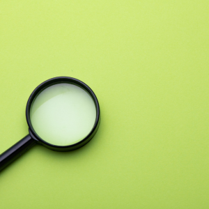 Magnifying Glass on Green Background